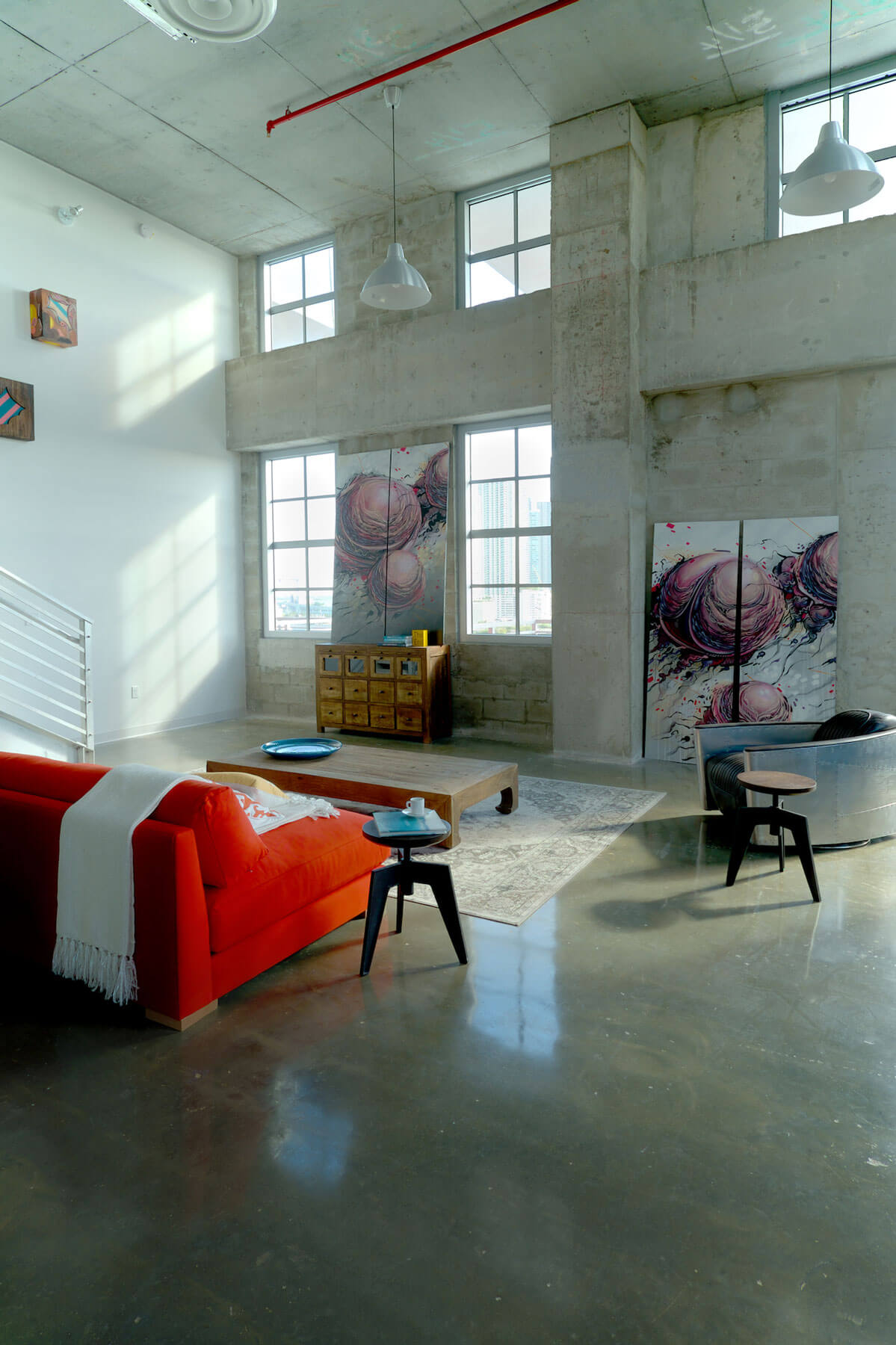 Large abstract paintings resting against the wall
