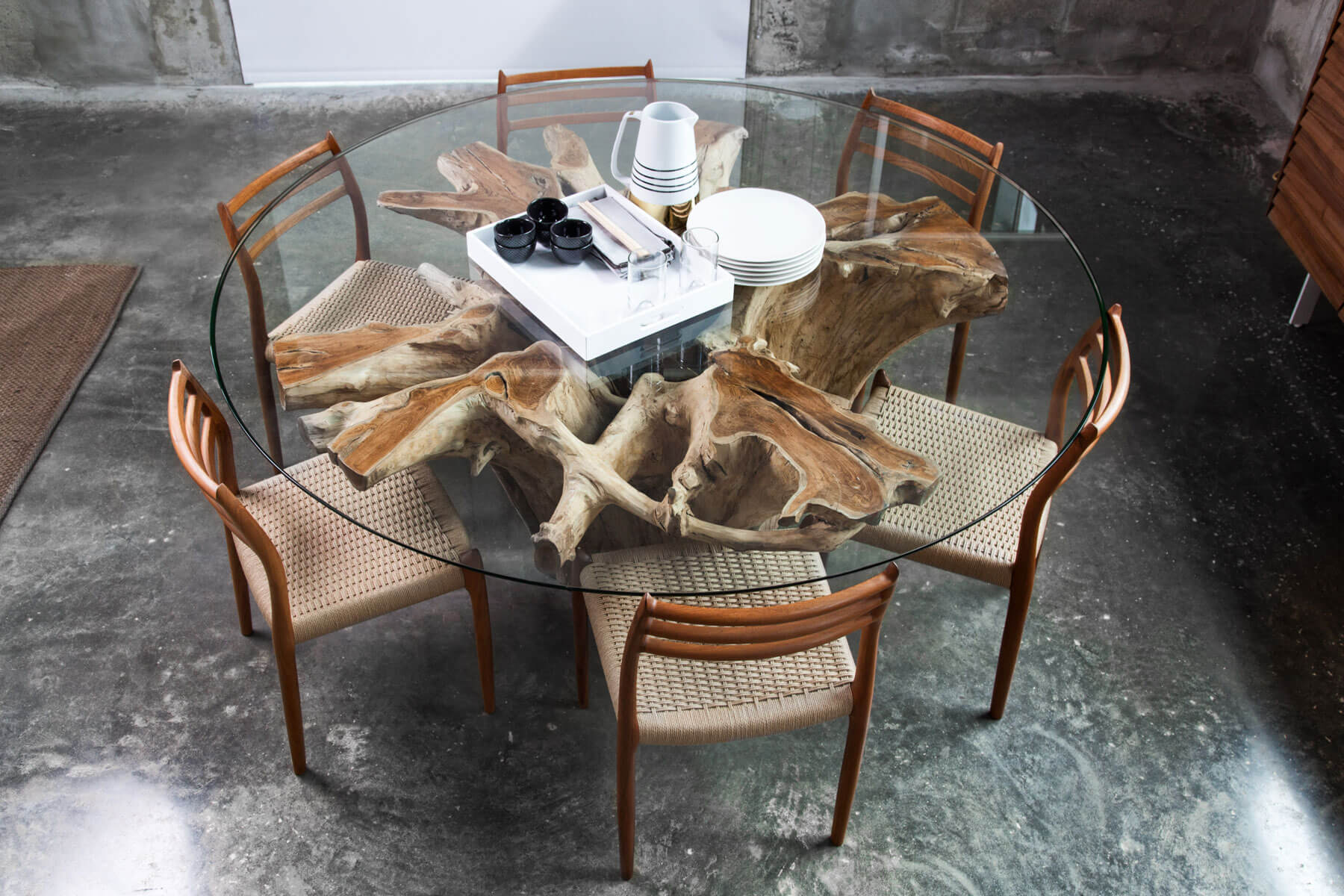 Round glass dining table with wood trunk base